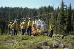 Firefighters loading helicopter to carry gear out of the site by Douglas Beck