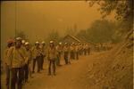 Several members of the ground crew on a road while preparing to fight the Hog Fire in the Klamath National Forest by Douglas Beck
