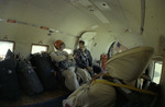 Three smokejumpers in the cabin of a DC-3 during a practice jump by Douglas Beck