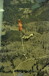 Two smokejumpers deploying parachutes just after their exit from the plane by Douglas Beck