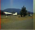 DC-3 transport plane on tarmac by Douglas Beck
