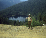 Smokejumper standing above lake by Douglas Beck