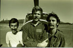 Portrait of three men in front of helicopter by Douglas Beck