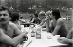 Men sitting around a picnic table by Douglas Beck