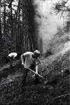 Two men digging with shovels by Douglas Beck