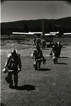 Smokejumpers walking from a Twin Otter by Douglas Beck