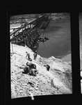 Workers on a cliff overlooking Grand Coulee Dam by Hubert Blonk
