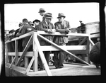 Harold Ickes and Frank Banks leaning on the railing of a train car by Hubert Blonk