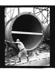 Worker turning hardware attached to a penstock liner by Hubert Blonk