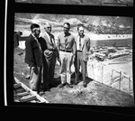 Four men standing atop the partially completed Grand Coulee Dam by Hubert Blonk