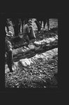 Worker laying sandbags by Hubert Blonk