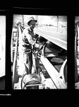 Worker at a conveyor belt by Hubert Blonk