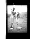 Two men playing baseball in dresses by Hubert Blonk