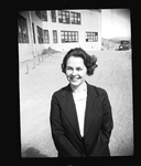 Portrait of woman standing outside building by Hubert Blonk