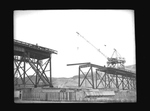 Construction of railway bridge above the foundation of Grand Coulee Dam by Hubert Blonk