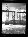 Construction of last section of railway bridge above the foundation of Grand Coulee Dam by Hubert Blonk
