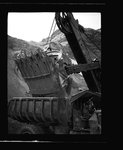 Power shovel drops earth into dump truck by Hubert Blonk