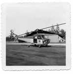 Helicopter on tarmac in front of L-5 hangar by Albert Boucher