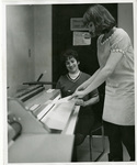 Two students operate a machine by Eastern Washington University