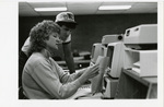 Two students review a computer print out by Eastern Washington University