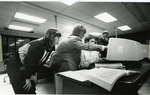Group of people working on a computer at a computer lab at Eastern Washington University by Eastern Washington University