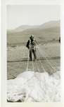 Unknown man(Beach Gill?) standing with an open parachute most likely after a jump by Albert Davies