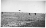 Skydiver lands during an air show in the late 1930s by unknown