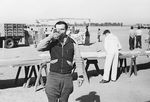 Frank Derry drinking from a glass at Mines Field in Los Angeles, California by unknown