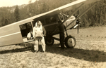 Frank Waite in a smokejumper jumpsuit outside an airplane by unknown