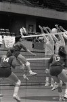 Juli Argotow spikes the volleyball through University of Montana blockers by Eastern Washington University