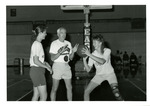 Bill Smithpeters coaching two women basketball players by Eastern Washington University