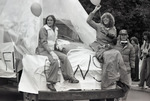 Ski club members on the hood of their homecoming parade float by Eastern Washington University