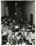 Christmas carols sung by students around a Christmas tree by Eastern Washington College of Education