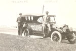 T. S. Lane and L. H. Brown in front of one of the official Mitchell Six cars for the National Parks Highway Association tour by Frank W. Guilbert