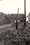 City limit sign asking drivers to slow down and respect the law by Frank W. Guilbert