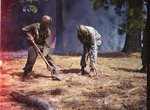 555th Parachute Infantry members shoveling around fire by Edgar W. Weinberger and United States. Army Air Forces